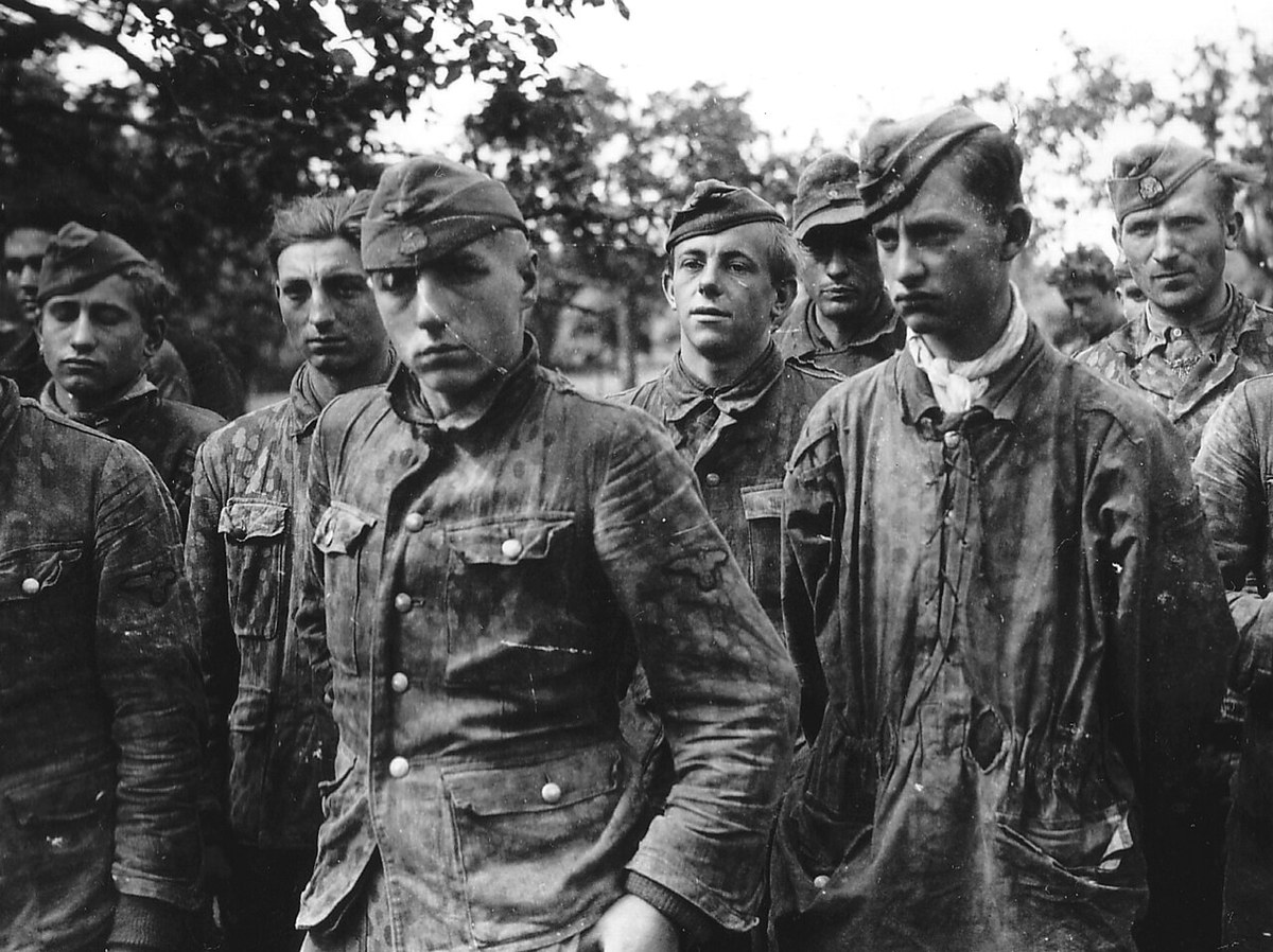 Waffen-SS prisoners taken in Normandy in 1944 wearing printed camouflage smocks