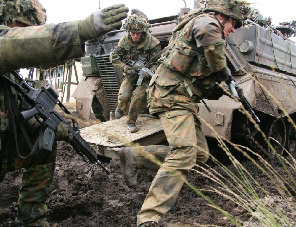 German Panzergrenadiers in Flecktarn dismounting from a Marder fighting vehicle