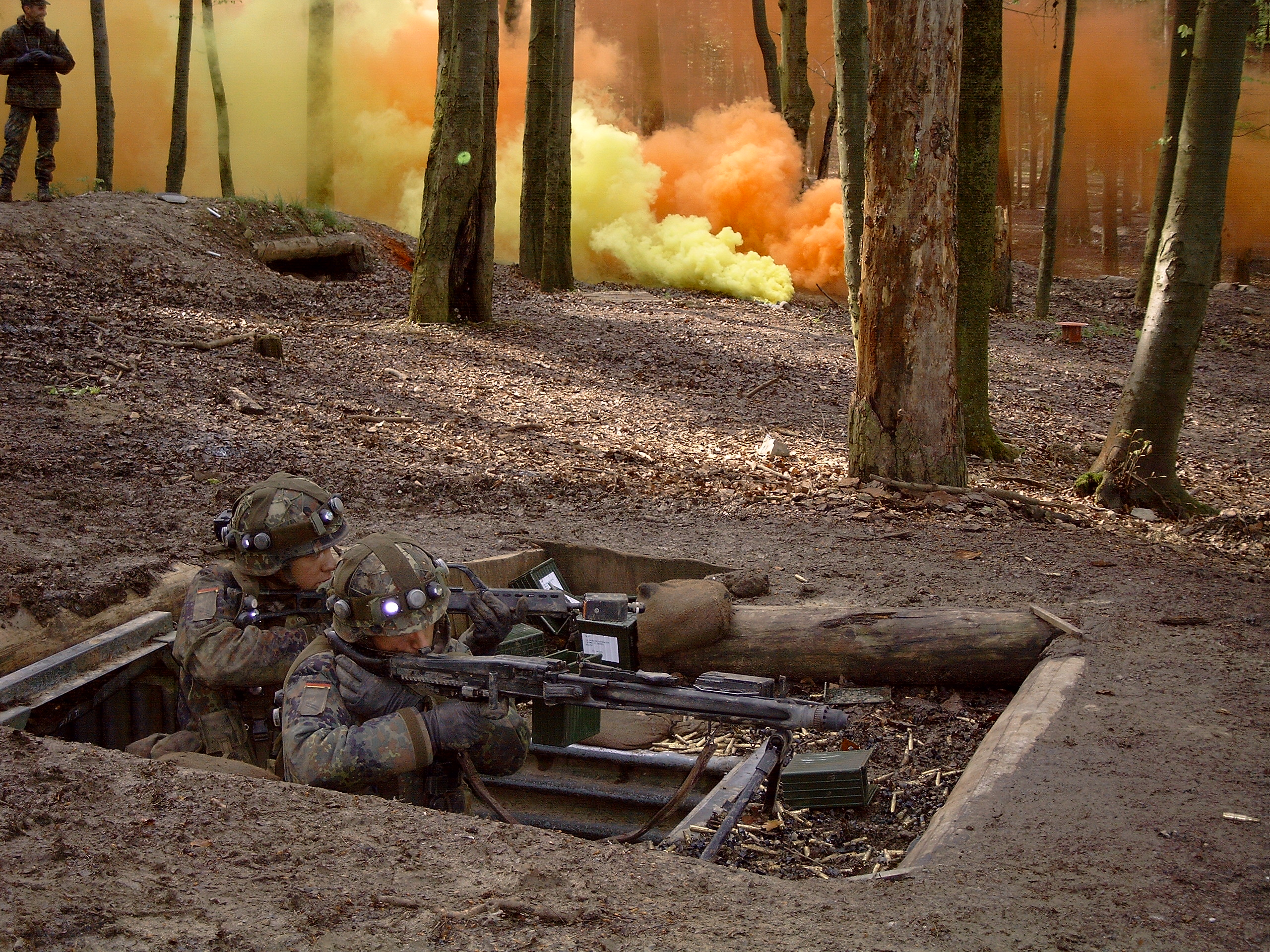 German paratroopers in Flecktarn camouflage defending a position in a wooded training area