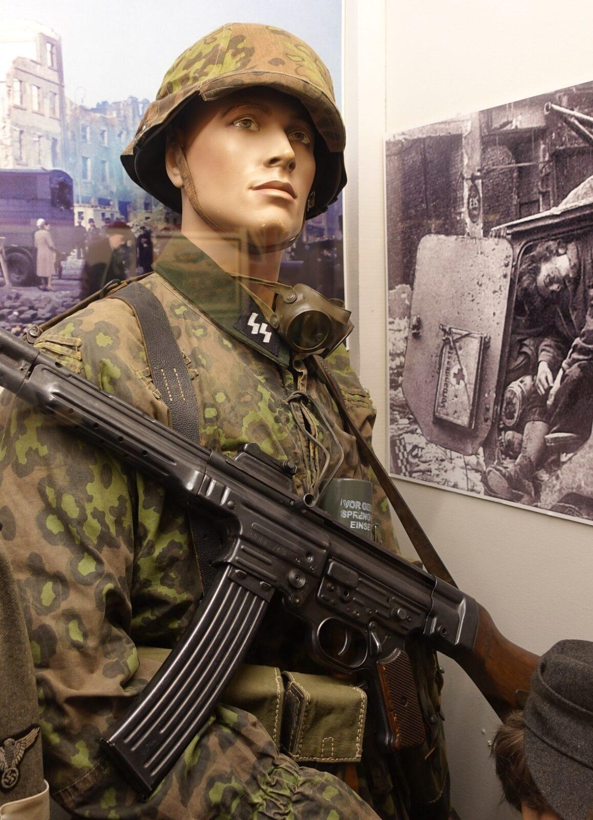 Waffen-SS camouflage smock and helmet cover printed in the autumn colouring of the Plane Tree pattern (Platanenmuster), on a museum display figure, Lofoten War Memorial Museum, Norway