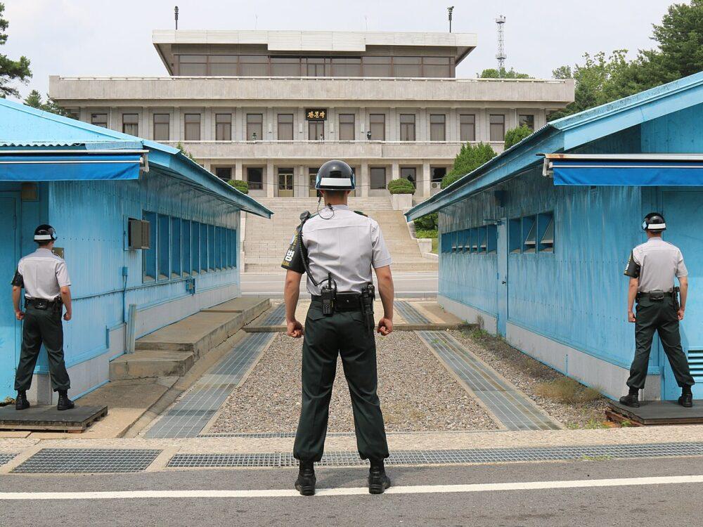 South Korean soldiers of the Joint Security Area security battalion standing guard at Panmunjom, the crossing point where soldiers of the two Koreas stand metres apart across the Military Demarcation Line, with the North Korean Panmungak building behind them, June 2018