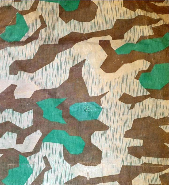 Splittertarn (Buntfarbenmuster 31) pattern — angular brown and green splinter shapes with fine rain streaks over a light ground