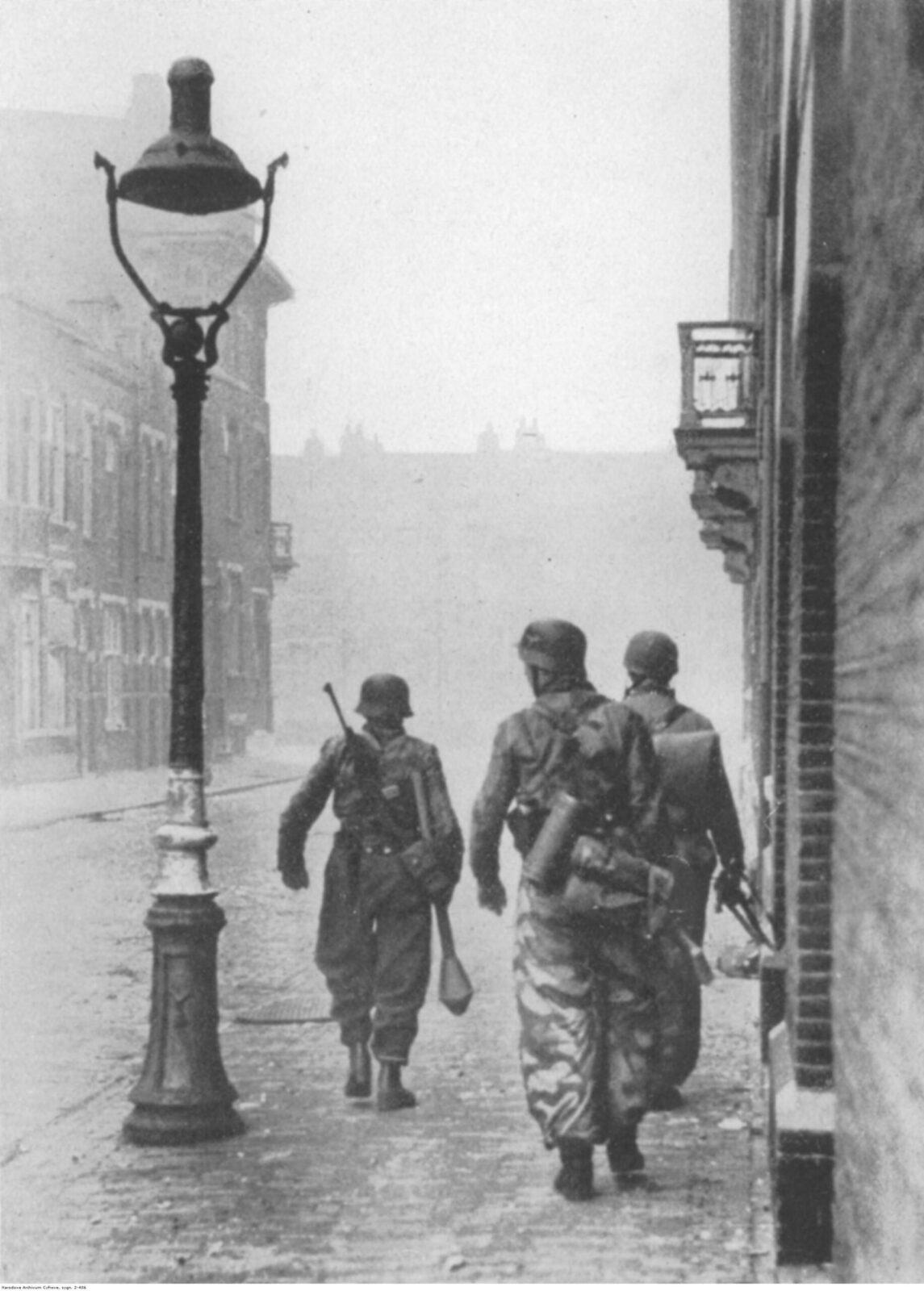German soldiers in camouflage smocks walking along a street, s-Hertogenbosch, November 1944