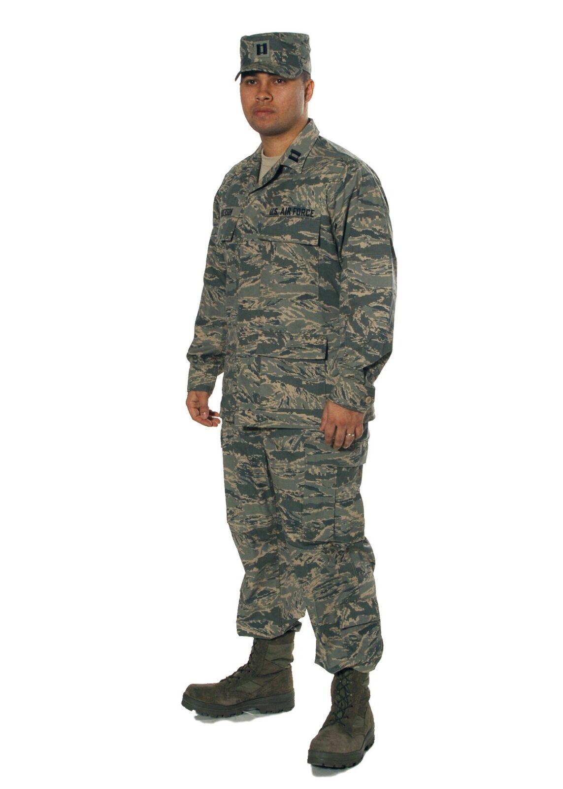 Airman Battle Uniform shown on a display form: coat with U.S. Air Force and name tapes, ABU patrol cap, and trousers bloused over sage green boots, in the Air Force's digitised tiger stripe pattern.