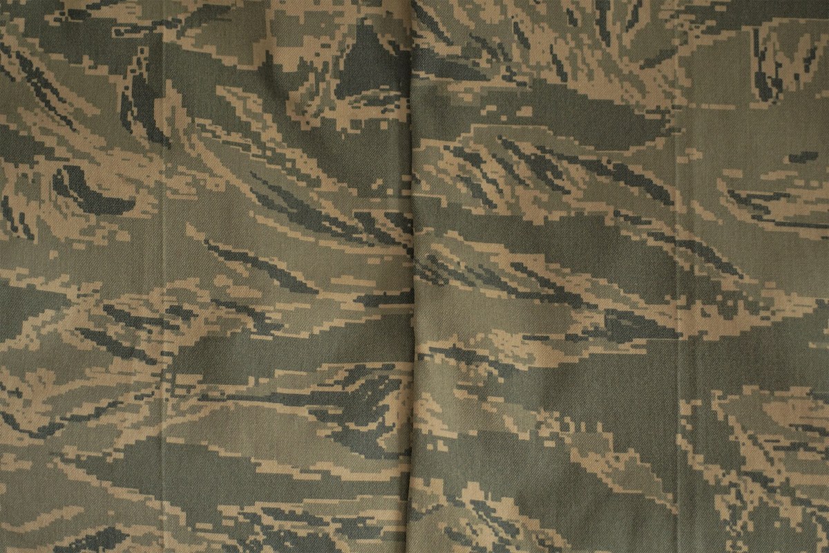 Airman Battle Uniform cloth in a darker, browner production shade, with horizontal tiger stripe bands in khaki, tan and dark olive grey.