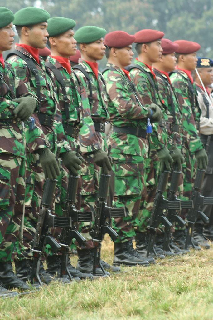 Indonesian Army soldiers in Malvinas DPM camouflage with green and red berets, the large green, dark red and cream blocks clearly visible