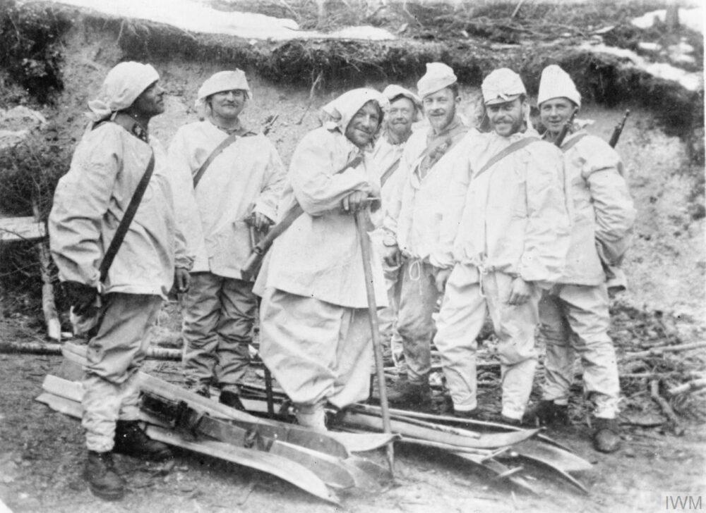 Ski patrol in white snow camouflage smocks and hoods with skis and poles, Italian front, First World War
